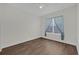 Empty bedroom with neutral colored walls, hardwood flooring and a window with blue curtains at 17572 Davenport Rd, Winter Garden, FL 34787