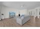 Bright living room with hard wood floors and stylish white furniture at 17572 Davenport Rd, Winter Garden, FL 34787