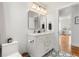 Modern bathroom features double vanity, sleek fixtures, and decorative mirrors at 1855 Cloverlawn Ave, Orlando, FL 32806