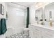 Elegant bathroom with tub, shower, dual sinks, and designer tile flooring at 1855 Cloverlawn Ave, Orlando, FL 32806