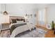 Inviting bedroom featuring wood floors, area rug, decorative lighting, and stylish headboard at 1855 Cloverlawn Ave, Orlando, FL 32806