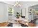 Charming dining area featuring modern lighting, a round table and view to the kitchen at 1855 Cloverlawn Ave, Orlando, FL 32806