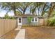 Charming single-story home with a cozy front yard, light grey stucco, a walkway and wood fence at 1855 Cloverlawn Ave, Orlando, FL 32806