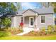 Charming home featuring manicured landscaping, a cozy porch and fresh, neutral paint at 1855 Cloverlawn Ave, Orlando, FL 32806