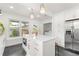 Bright, modern kitchen with island, stainless steel appliances, and white cabinetry at 1855 Cloverlawn Ave, Orlando, FL 32806