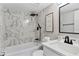 Modern bathroom featuring a black rainfall shower head and marbled tile surround at 1920 E Edgewood Dr # A5, Lakeland, FL 33803
