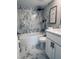 Bathroom featuring tiled shower/tub combo with marble-look tile and gray vanity at 1920 E Edgewood Dr # A5, Lakeland, FL 33803