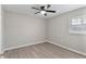 Well-lit bedroom with a ceiling fan, vinyl floors, and a bright window view at 1920 E Edgewood Dr # A5, Lakeland, FL 33803
