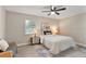 Bedroom with a ceiling fan, a window, and a bed with a white comforter and an area rug at 1920 E Edgewood Dr # A5, Lakeland, FL 33803