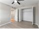 Bright bedroom with neutral walls, modern vinyl floors, and a double-door closet at 1920 E Edgewood Dr # A5, Lakeland, FL 33803