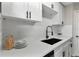 Bright kitchen features white cabinets, quartz countertops, stainless appliances, and black hardware at 1920 E Edgewood Dr # A5, Lakeland, FL 33803