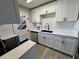 Bright kitchen features white cabinets, gray counters, modern black faucet, and stainless steel dishwasher at 1920 E Edgewood Dr # A5, Lakeland, FL 33803