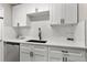 Well-lit kitchen with white cabinetry, quartz countertops, and stainless steel appliances at 1920 E Edgewood Dr # A5, Lakeland, FL 33803