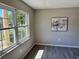 Living room with gray walls, wood-look flooring, and a large window at 1920 E Edgewood Dr # A5, Lakeland, FL 33803