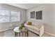 Comfortable living room with a white couch, modern art, and a bright window with natural light at 1920 E Edgewood Dr # A5, Lakeland, FL 33803