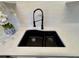 Close up of the kitchen sink with gray countertops and white subway tile backsplash at 1920 E Edgewood Dr # A5, Lakeland, FL 33803