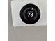 Image of a white smart thermostat with a digital display set to 73 degrees at 1920 E Edgewood Dr # A5, Lakeland, FL 33803