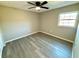 Cozy bedroom with neutral paint, vinyl plank flooring, ceiling fan, and a bright window at 1920 E Edgewood Dr # A9, Lakeland, FL 33803