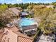 Aerial view of a sparkling community pool with pergola, surrounded by lush trees and residential buildings at 19914 Villa Creek Dr # 105, Orlando, FL 32821