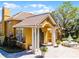 Stunning yellow exterior showcasing a tile roof, grand columns, water feature, and manicured landscaping at 19914 Villa Creek Dr # 105, Orlando, FL 32821