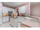 Well-lit kitchen featuring a movable island, white cabinetry, and a tiled backsplash, offering a functional layout at 2029 Majestic Elm Blvd, Ocoee, FL 34761