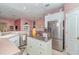 Bright kitchen featuring stainless steel appliances, white cabinetry, and a mobile island with a stainless steel countertop at 2029 Majestic Elm Blvd, Ocoee, FL 34761