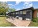 Screened patio features metal furniture on a brick patio with cloudy blue sky at 2029 Majestic Elm Blvd, Ocoee, FL 34761