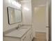 Bright bathroom featuring a sleek vanity with quartz countertop and modern fixtures and a dark framed mirror at 216 Homewood Dr, Sanford, FL 32773