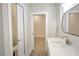 Well-lit bathroom featuring a modern vanity with quartz countertop and a view into the adjoining room at 216 Homewood Dr, Sanford, FL 32773