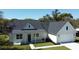 Aerial view of home with a dark roof, manicured lawn, and inviting front porch at 216 Homewood Dr, Sanford, FL 32773