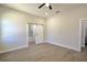 Spacious main bedroom with sliding barn door leading to main bathroom, ceiling fan and recessed lighting and windows at 216 Homewood Dr, Sanford, FL 32773