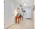 Inviting hallway with neutral tile flooring, fresh paint, and decorative accents, creating a welcoming entrance at 2165 Leather Fern Dr, Ocoee, FL 34761