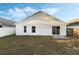 View of the backyard featuring a sliding glass door, a fenced yard, and a concrete patio at 237 Clarinet Way, Davenport, FL 33896