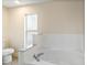 Bright bathroom featuring soaking tub with a marble backsplash and large vanity mirror at 237 Clarinet Way, Davenport, FL 33896