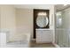 Bathroom showcasing a glass shower, vanity, and a soaking tub with a marble backsplash at 237 Clarinet Way, Davenport, FL 33896