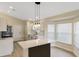 Open kitchen boasts a central island, modern pendant lighting, and stainless steel appliances at 237 Clarinet Way, Davenport, FL 33896