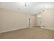 Spacious living room with light-tone wood floors, modern lighting, and view into hall at 237 Clarinet Way, Davenport, FL 33896