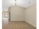 Open living room with light-tone wood floors, ceiling fan, and view into the fenced backyard at 237 Clarinet Way, Davenport, FL 33896