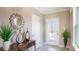 Inviting entryway with a decorative mirror, modern door, and tiled floors at 2743 San Marco Way, Winter Haven, FL 33884