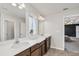 Double sink bathroom with a large mirror and dark wood cabinets at 3005 Slough Creek Dr, Kissimmee, FL 34744