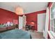 Red bedroom with a dresser and work space at 3005 Slough Creek Dr, Kissimmee, FL 34744