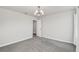 Neutral bedroom with carpet flooring and a modern light fixture at 3005 Slough Creek Dr, Kissimmee, FL 34744