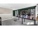 Expansive bonus room offering versatile space with bookshelves and access to a well-lit adjacent area at 3005 Slough Creek Dr, Kissimmee, FL 34744