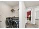 Efficient laundry room with modern washer and dryer set, offering convenience and functionality at 3005 Slough Creek Dr, Kissimmee, FL 34744