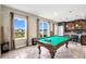 Billiard room showcasing a pool table and views of the backyard, kitchen, and natural light at 3005 Slough Creek Dr, Kissimmee, FL 34744