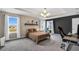 Carpeted main bedroom with a view to the outside, a statement wall, and a modern light fixture at 3005 Slough Creek Dr, Kissimmee, FL 34744