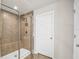 Close up of tiled walk-in shower with a shower bench and glass door at 3005 Slough Creek Dr, Kissimmee, FL 34744