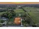 Aerial view of equestrian estate with white perimeter boundary lines and horse training area at 31707 Orange St, Sorrento, FL 32776