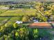 Wide angle aerial view of the property with horse training area, pool, and pastures at 31707 Orange St, Sorrento, FL 32776