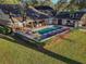 Aerial view of backyard, showcasing pool, lounge area, and outdoor kitchen at 31707 Orange St, Sorrento, FL 32776